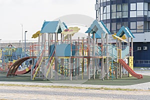 Modern children`s playground near high-rise buildings