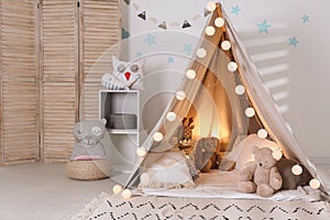 Modern children`s room interior with play tent and lights
