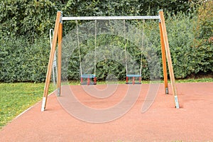 Modern children\'s swing on the playground in the park