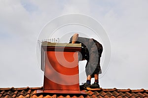 A modern chimney sweep checking out the chimney from the inside to see if it needs repair