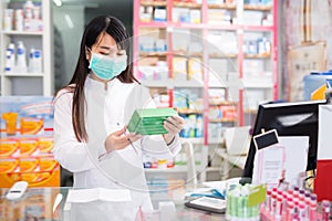 Modern chinese druggist in protective facial mask