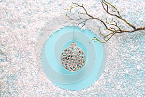 Modern Christmas holiday ornament decorations with sparkling tinsel on blue background. Flat lay with copy space