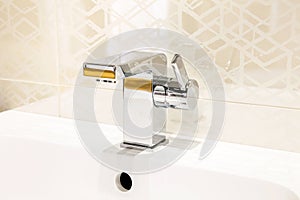 Modern chrome faucet in bathroom