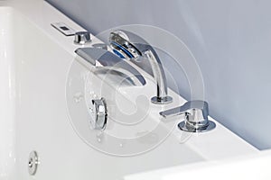 Modern chrome faucet in bathroom