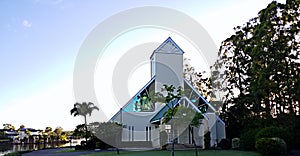 Modern Church at sunrise place of worship in natural setting and blue sky backing