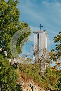 Modern Church Tower with Big Metal Cross. Modern church tower crowned with iron crosses on sunset sky background