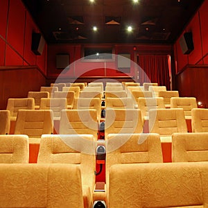 Modern cinema hall empty and beige comfortable seats