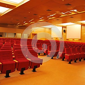 Modern cinema hall empty and red comfortable seats