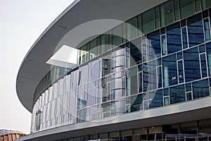 Modern circular building with windows in the Gae Aulenti square.