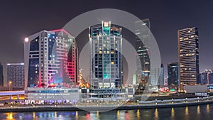 Modern city architecture in Business bay district. Panoramic view of Dubai's skyscrapers night timelapse