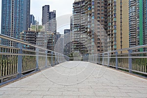 Modern city buildings background with empty road floor