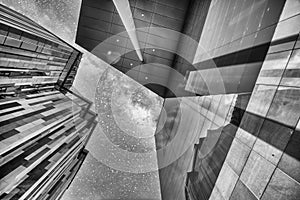 Modern city buildings in the business center, upward skyward view at night with stars in the sky