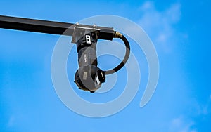 Modern city CCTV camera set against a blue sky