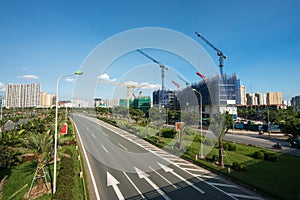 Modern city with highway traffic and building under construction. Hanoi city, Thang Long highway