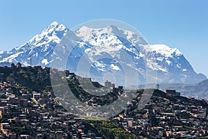 The modern city of La Paz in Bolivia overshadowed by Illimani.