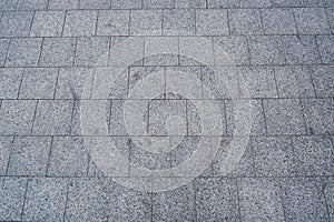 Modern city road paved with granite gray stone. texture Modern stone pavement in the city