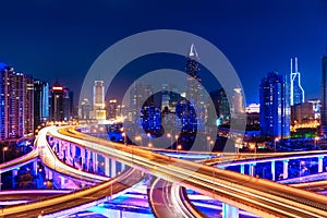 Modern city skyline with interchange overpass at night