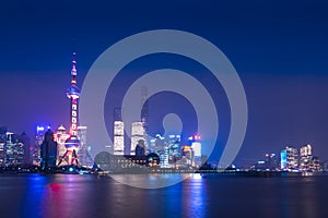 Modern city skyscrapers of Shanghai skyline at night with reflection of beautiful ligth in Huangpu river view from