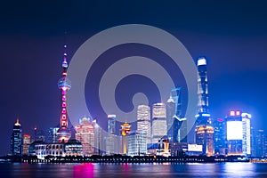 Modern city skyscrapers of Shanghai skyline at night with reflection of beautiful ligth in Huangpu river view from