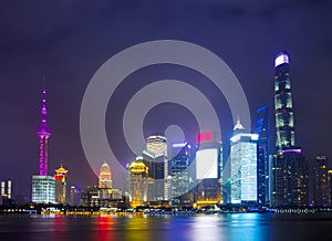 Modern city skyscrapers of Shanghai skyline at night with reflection of beautiful ligth in Huangpu river view from