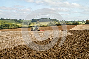 Modern claas tractor cultivating field