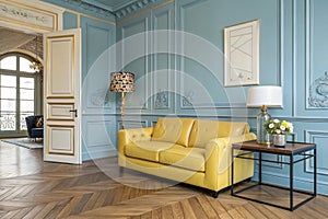 Modern classic blue and yellow interior with leather sofa and table
