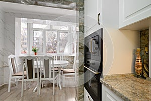 Modern classic white kitchen interior with dining zone