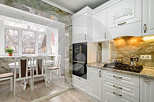 Modern classic white kitchen interior with dining zone