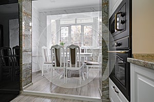 Modern classic white kitchen interior with dining zone