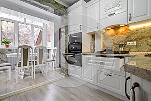 Modern classic white kitchen interior with dining zone