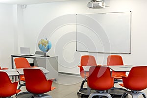 Modern classroom interior, with white board and movable tables and chairs photo
