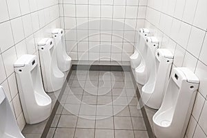 Modern clean hygienic men urinal ware in public washroom toilet