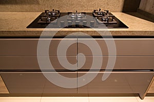 Modern clean kitchen cabinets and glass ceramic built-in gas oven