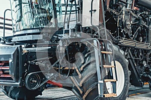 Modern combine harvester or tractor on production line of assembly manufacturing plant or factory. Agriculture