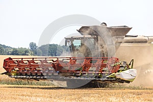 Modern combine harvests a wheat field