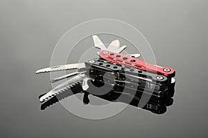Modern compact portable multitool on grey table