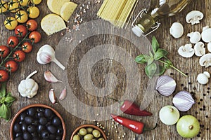 Modern composition of fresh food and ingredients on the vintage wooden table in the kitchen. Italian taste and look. Top view.