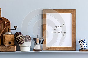 Modern composition on the kitchen interior with mock up photo frame, wooden cutting board, herbs, vegetables .