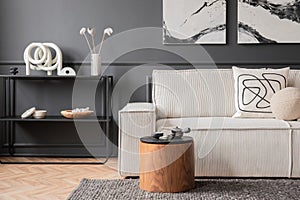 Modern composition of living room interior with mock up poster frame, modular sofa, black consola, sculpture, wooden coffee table