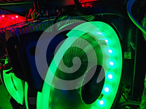 Modern computer air cooling with multi-colored led backlight-fans, cooling radiators, cables, boards, close-up, macro.