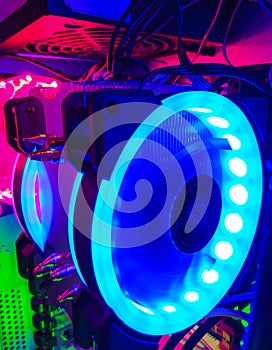 Modern computer air cooling with multi-colored led backlight-fans, cooling radiators, cables, boards, close-up, macro.