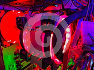 Modern computer air cooling with multi-colored led backlight-fans, cooling radiators, cables, boards, close-up, macro