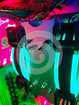 Modern computer air cooling with multi-colored led backlight-fans, cooling radiators, cables, boards, close-up, macro.