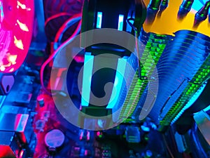 Modern computer air cooling with multi-colored led backlight-fans, cooling radiators, cables, boards, close-up, macro.