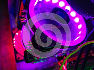 Modern computer air cooling with multi-colored led backlight-fans, cooling radiators, cables, boards, close-up, macro