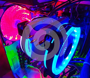 Modern computer air cooling with multi-colored led backlight-fans, cooling radiators, cables, boards, close-up, macro