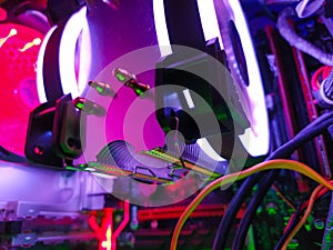 Modern computer air cooling with multi-colored led backlight-fans, cooling radiators, cables, boards, close-up, macro.