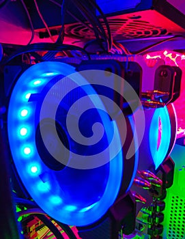 Modern computer air cooling with multi-colored led backlight-fans, cooling radiators, cables, boards, close-up, macro.