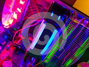 Modern computer air cooling with multi-colored led backlight-fans, cooling radiators, cables, boards, close-up, macro.