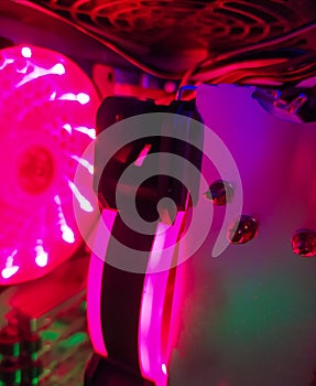 Modern computer air cooling with multi-colored led backlight-fans, cooling radiators, cables, boards, close-up, macro.